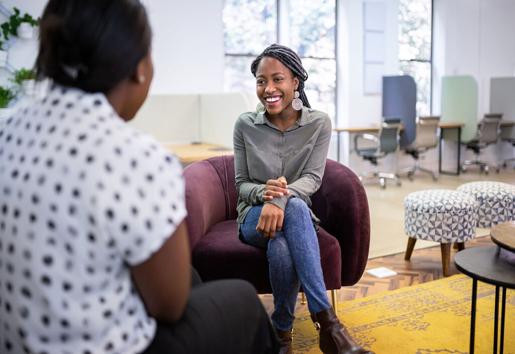 A young woman sitting in a chair using the STAR method for her interview